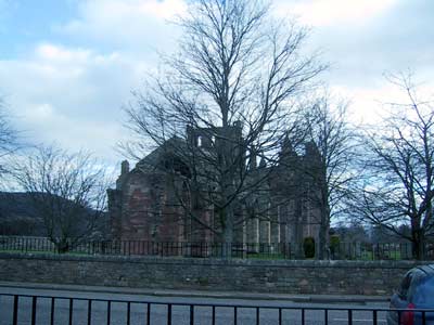Melrose Abbey perceived through winter trees